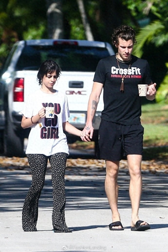 萌德和女友卡妹现身街头，手上都拿着马克杯，手牵手好恩爱